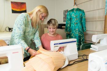 Latora Lezotte '20, a theatre degree major, and Prof. Kim Instenes work on a costume for a theatr...